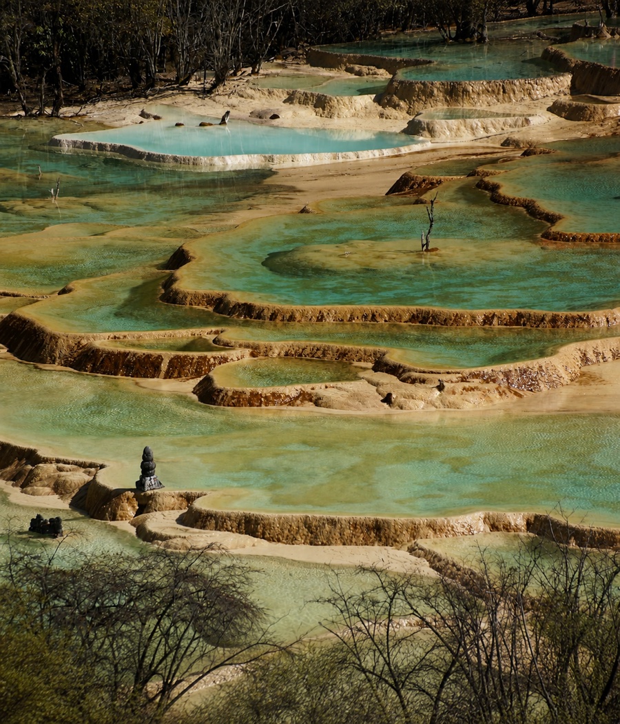 Turquoise travertine pools cascading through the Huanglong landscape in northern Sichuan