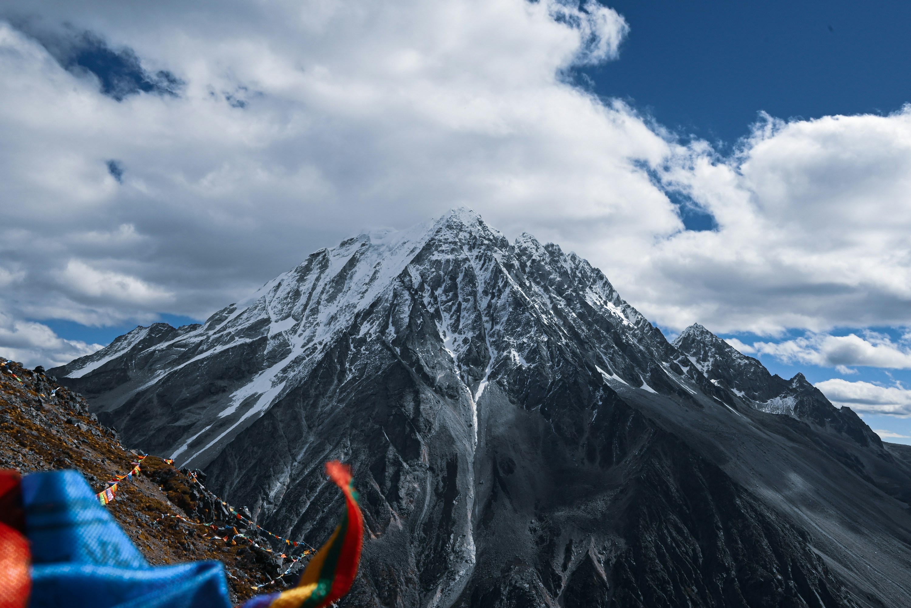 Prayer flags overlooking snow-covered Mount Yala in Western Sichuan