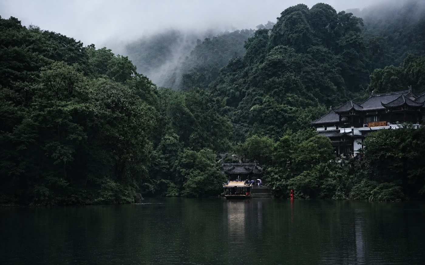 Misty forest, lake and Taoist buildings at Mount Qingcheng